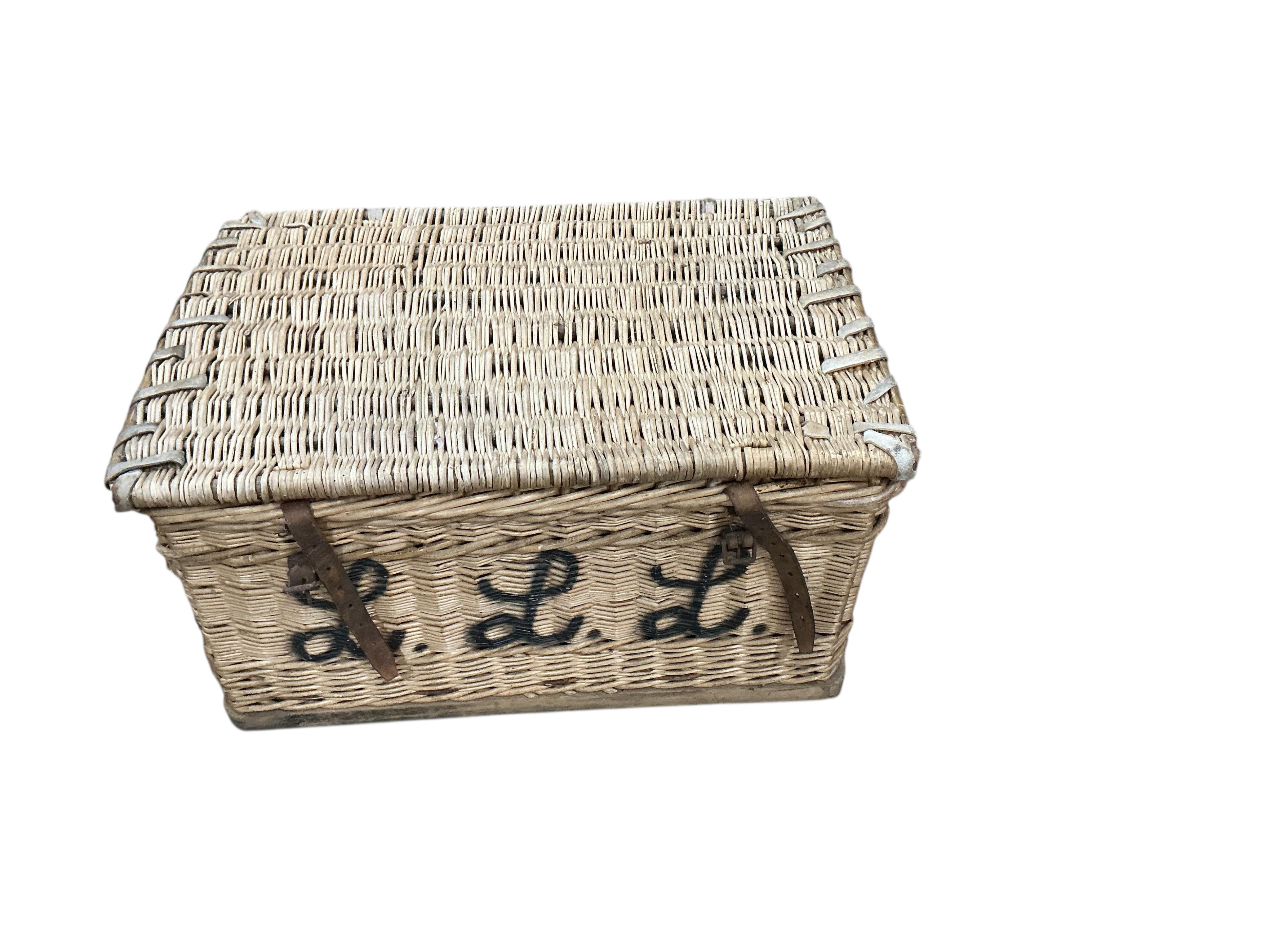 A WWI leather artillery shell case carrier, height 98cm, a wicker laundry hamper and a Revelation leather case